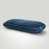 Blue quilted mattress viewed from the side at the bottom of the frame with light gray background.